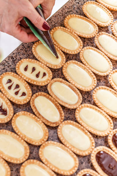 istock Woman hand decorating mini tarts 826622688