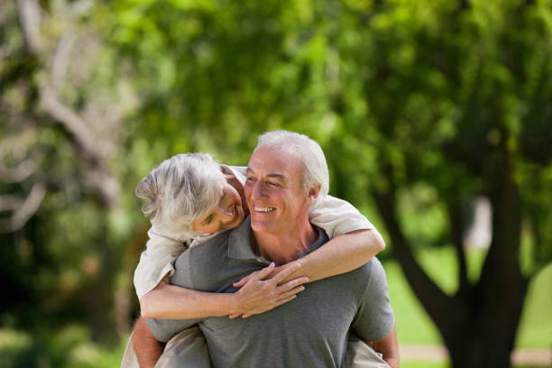 istock Man giving wife a piggyback 826625666