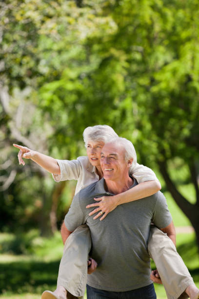 istock Man giving wife a piggyback 826626744