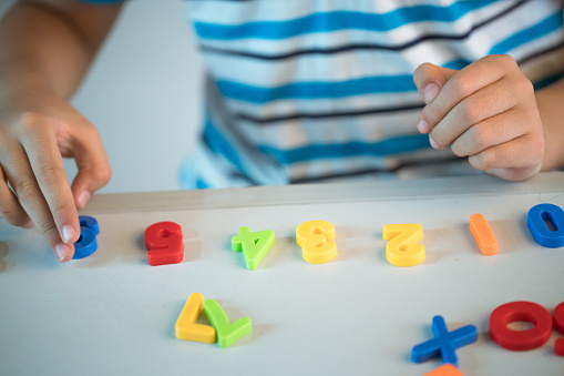 asian boy playing with numbers