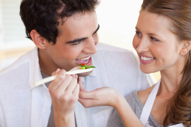 istock Smiling couple enjoys cooking together 826629978