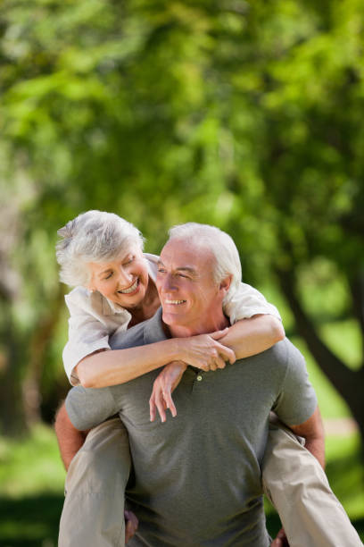 istock Man giving his wife a piggyback 826631008