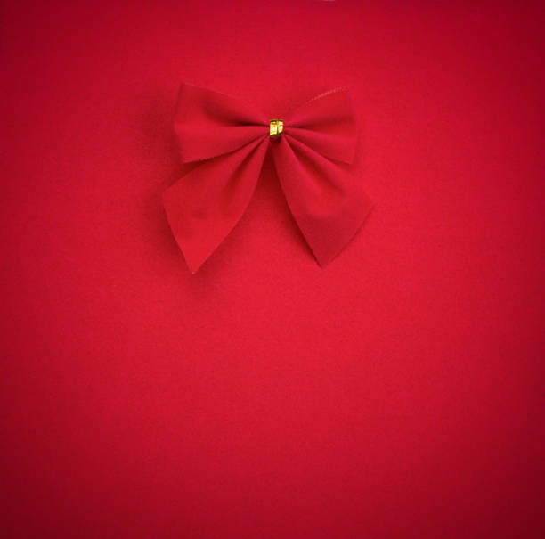 istock red bow on red background with vignette. mock up for text, congratulations, phrases, lettering 826634338