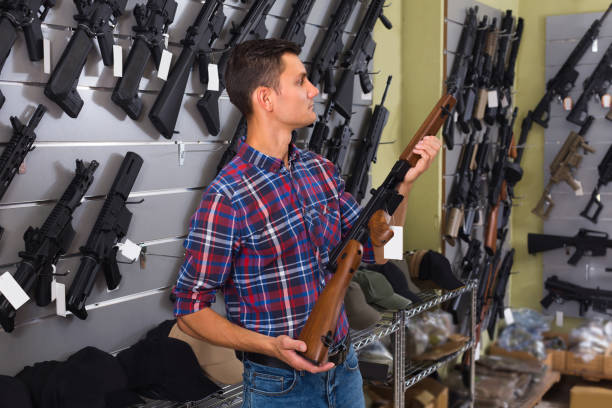 istock Male customer is choosing air-powered gun 826634504