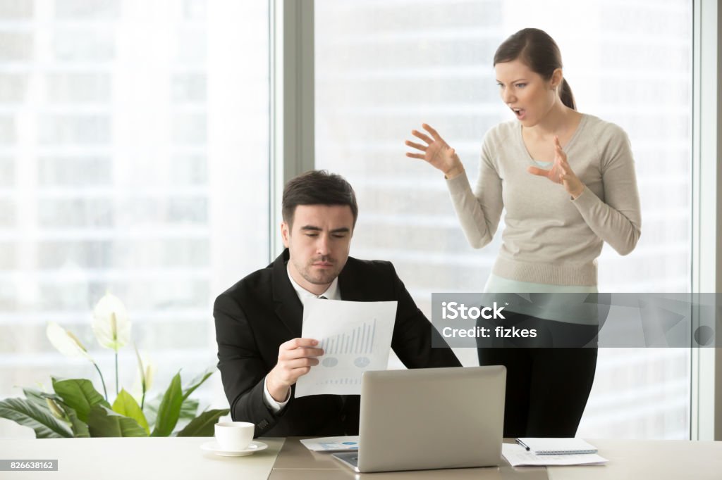 Employee Being Disrespectful To Boss Disrespectful Employee Grimacing Making Faces Behind Back Of Serious