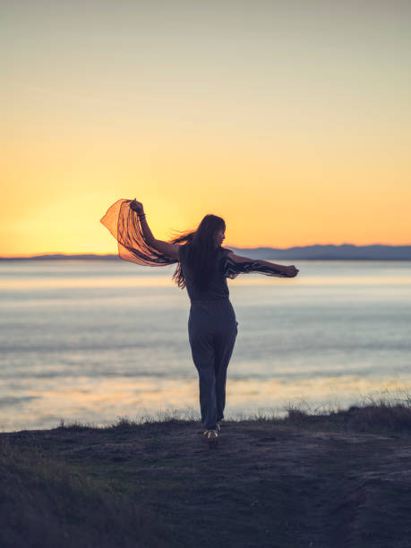 istock beautiful asian woman standing at Friday Harbor during sunset 826638408