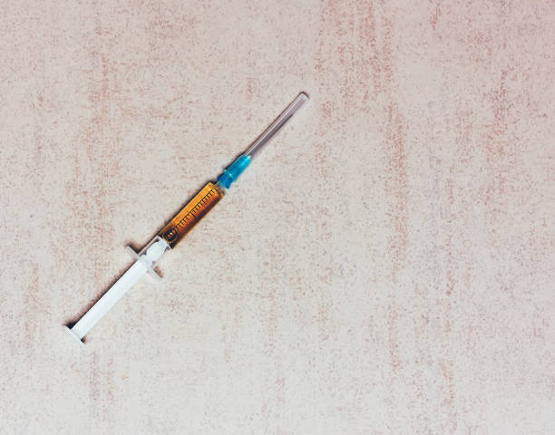 istock disposable medical syringe with needle for injection on a gray background with space for text 826638640