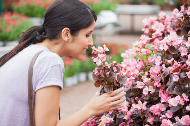 istock Blackhaired woman smelling flower 826645732