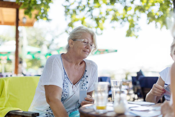 istock Senior friends in outdoor cafe 826649076