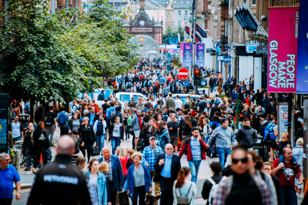 Large group of people in Buchanan Street. Glasgow. Glasgow, United Kingdom. 11 July 2017 - A largew group of people waking on Buchanan Street. This street is one of the main shopping spots in Glasgow. glasgow scotland stock pictures, royalty-free photos & images