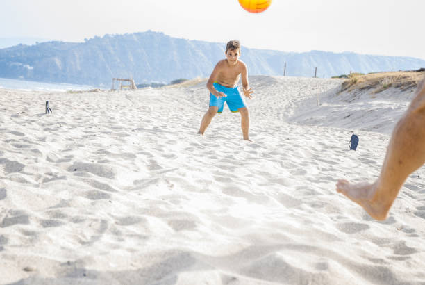 istock Playing Soccer at the Beach 826653830
