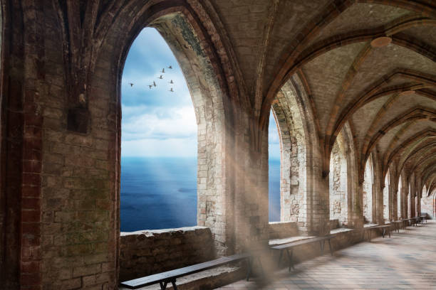 istock fantasy monastery archway with view to ocean an sunrays 826657774