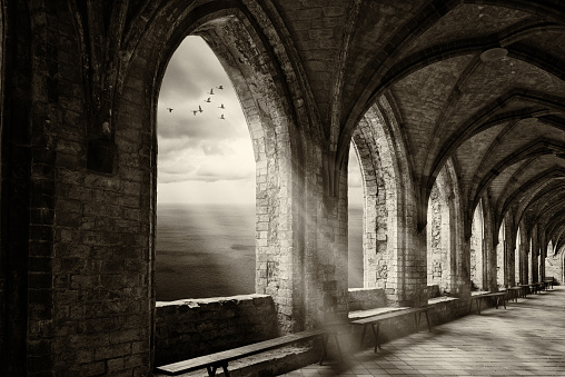 fantasy monastery archway with view to ocean an sunrays