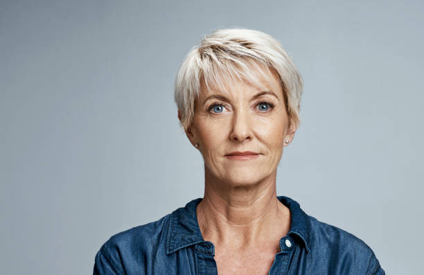 Ready to face whatever life sends my way Studio portrait of a mature woman posing against a grey background short hair photos stock pictures, royalty-free photos & images