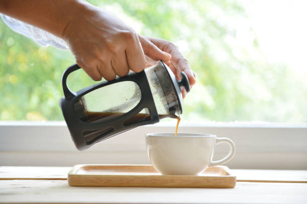 istock Hands holding french press coffee pot and white cup 826660644