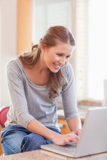 istock Woman surfing the internet in the kitchen 826662418