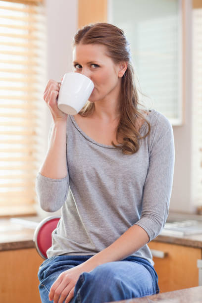istock Woman drinking coffee in the kitchen 826664828