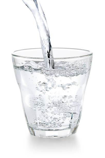 istock water flow filling a glass 826665514
