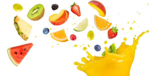 fruit cocktail falling into splashing yellow juice stock photo