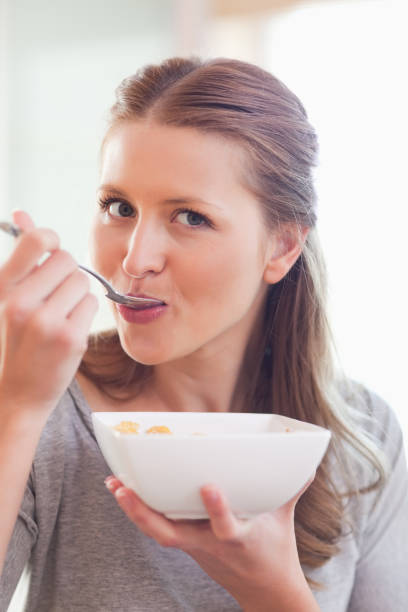 istock Close up of female having cereals for breakfast 826666708