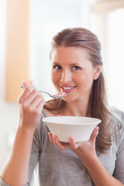 istock Woman having some cereals for breakfast 826667864