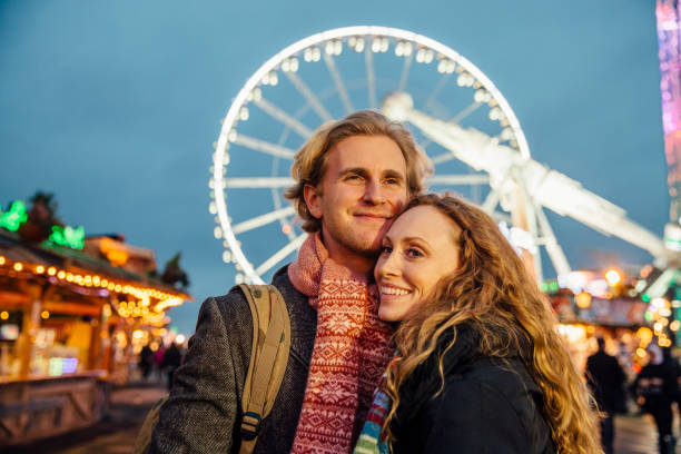 istock Couple Enjoying The Christmas Fair 826668604