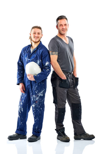 istock Young foreman with mechanic looking at camera on white 826669412