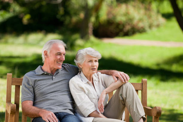 istock Senior couple sitting on a bench 826673810