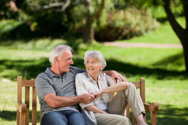 istock Senior couple sitting on a bench 826676790