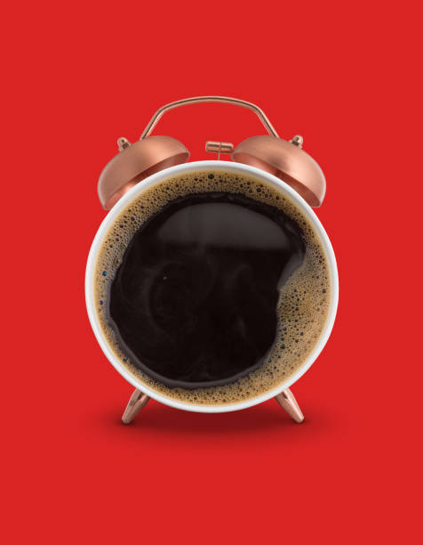 Twin bell alarm clock with coffee mug stock photo