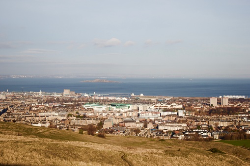 View across Leith and the island of Inchkeith in the Firth of Forth seen from Holyrood Park. Hibernian FC's Easter Road stadium can be seen in the centre. December 29th 2016.