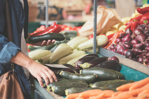 istock Young man holding paprika and eggplant 826686030