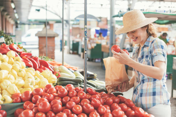 istock Woman shopping tomatoes on market 826686720