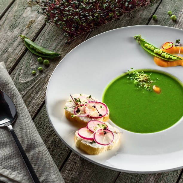 istock Pea cream soup in rim soup plate 826691956
