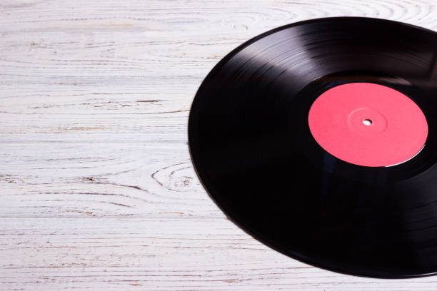 istock vinyl disc isolated on the wooden table 826703606