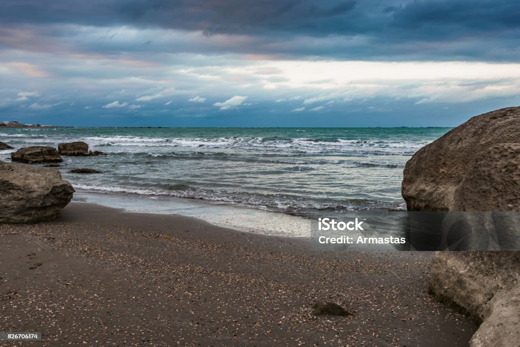 Dramatic beautiful seascape Sea shore in cloudy weather, storm on sea Animals In The Wild Stock Photo