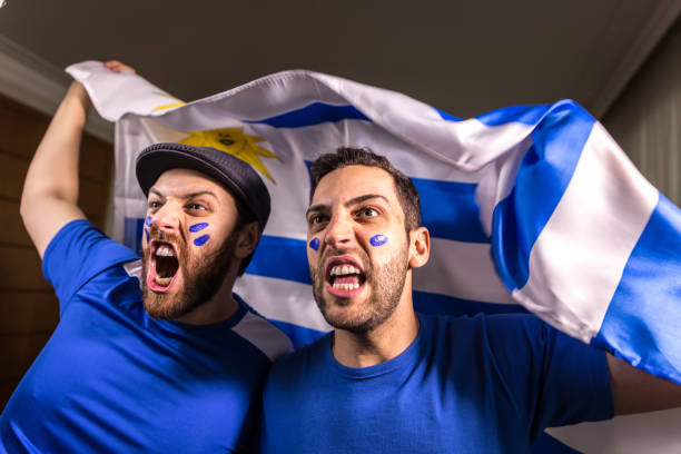 istock Uruguayan fans holding the national flag 826708504