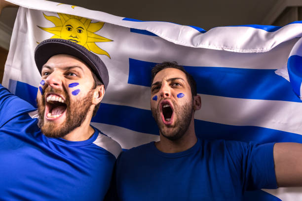 istock Uruguayan fans holding the national flag 826708506