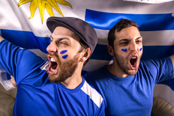 istock Uruguayan fans holding the national flag 826708518
