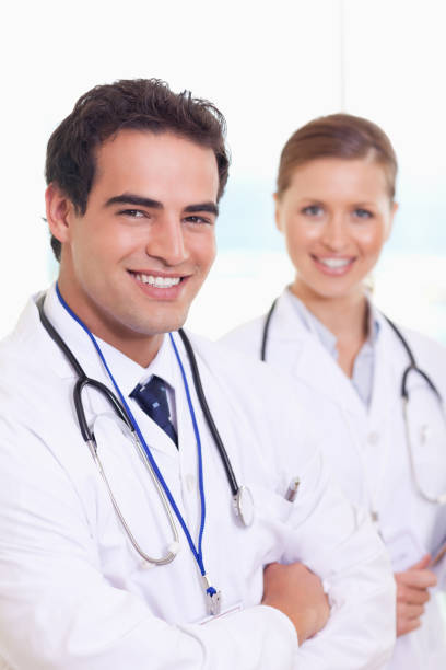 istock Smiling medical team standing next to each other 826708922