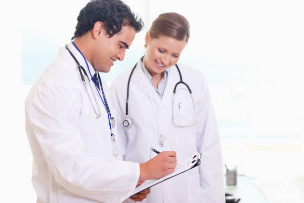 istock Young medical staff working on patient record 826709400