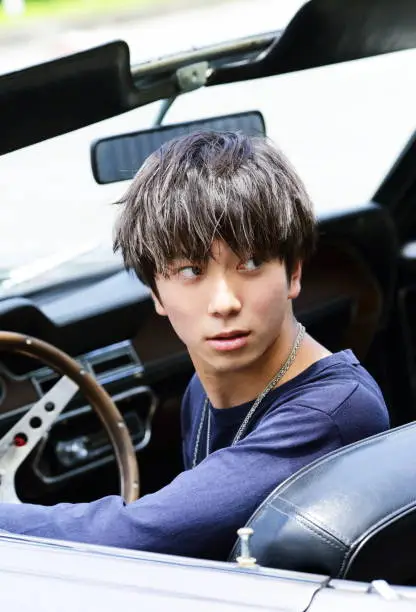 Photo of Young man driving in convertible car