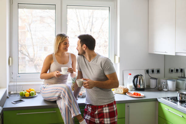 istock Romantic couple drinking coffee and flirting in the kitchen 826714058