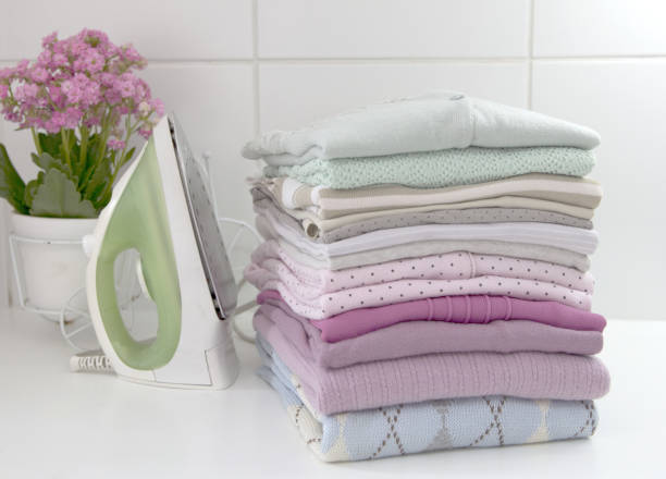 Clothes laundry Clothes pile folded in laundry. Ironing background. iron laundry cleaning ironing board stock pictures, royalty-free photos & images