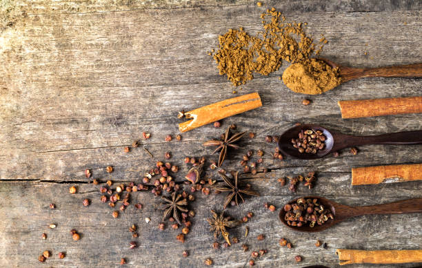istock Herbs and spices on a wooden board. Spice spoon. 826716994