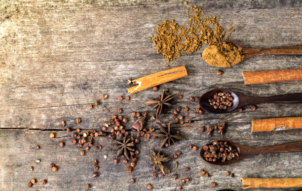 istock Herbs and spices on a wooden board. Spice spoon. 826717236