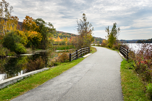Curving Cycle Path alongside a Mountain Lake in the Berkshires, MA, on a Cloudy Autumn Day.