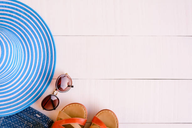 istock Flat lay blue hat sunglasses and shirt shoe on white wood table 826720552