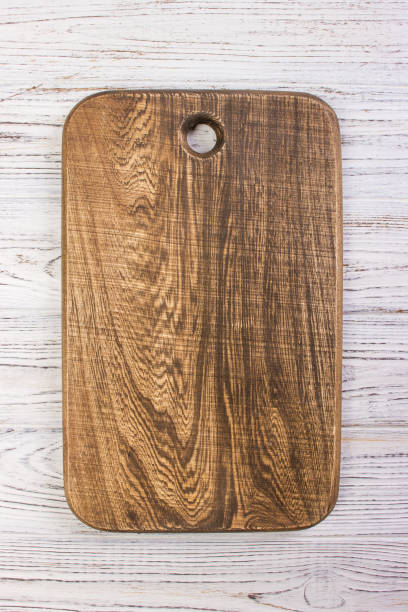 istock Wooden chop board on rustic wooden table top. Top view. 826723382