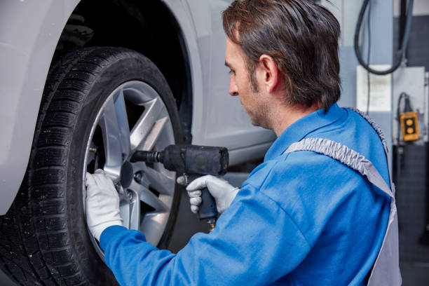 istock Tire repairer changing the car tire 826728286